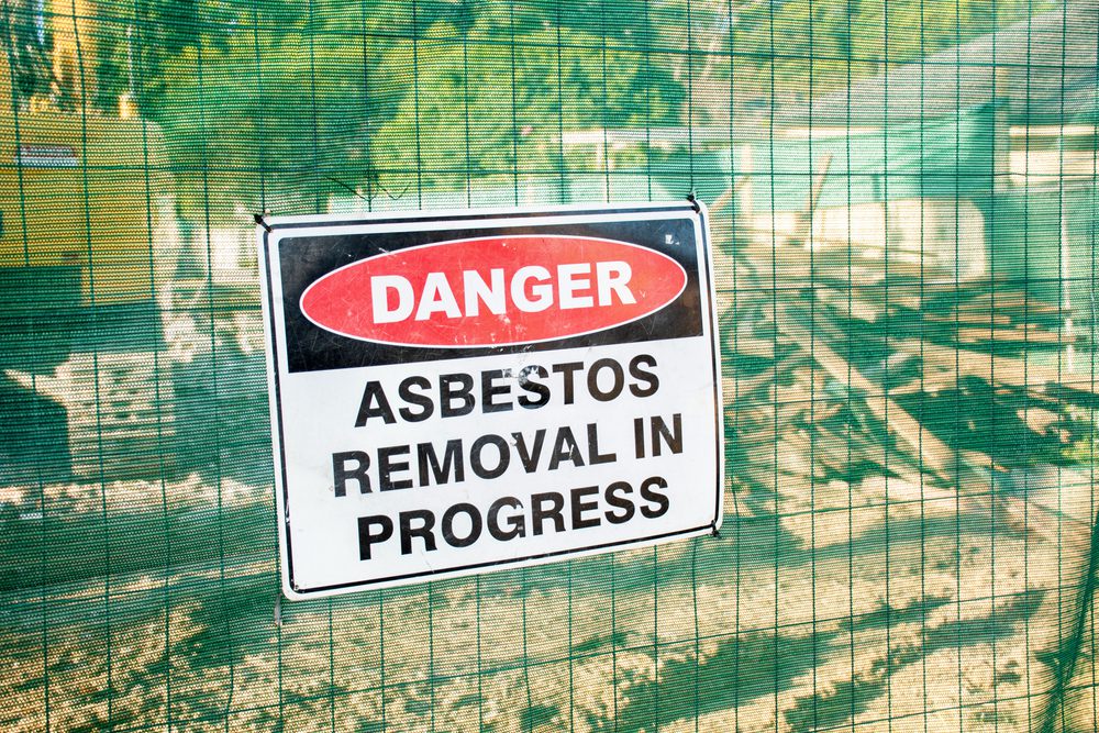A,Warning,Sign,Danger,Asbestos,On,A,Fence,At,Construction